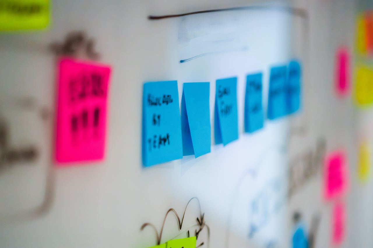 why-choose-us Sticky notes on a whiteboard during a creative brainstorming session in an office.