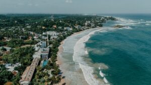 Explore Sri Lanka's stunning coastline, lush forests, and vibrant townscape from above. Perfect for travel inspiration.